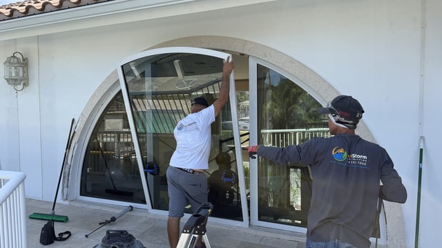 SunStorm three-man crew setting arched impact window — 530 Lido Dr, Fort Lauderdale